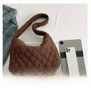 Deep brown corduroy quilted tote bag showing large capacity with tablet and phone