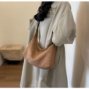 Detail view of brown frosted suede tote bag showing soft matte texture and stitching