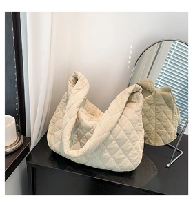 Close-up of quilted beige corduroy tote bag texture and soft diamond pattern details