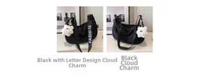 Detail of black nylon dumpling bags featuring fashion straps and plush bear pendants