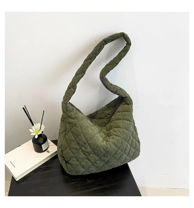 Detail of olive green corduroy tote bag with quilted diamond pattern and soft texture