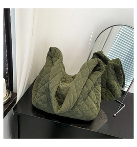 Detailed texture of army green corduroy tote bag with quilted diamond pattern