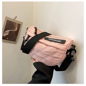 Detail of pink quilted nylon chest bag with fashion logo and black strap