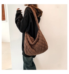 Detail of dark brown quilted corduroy tote bag showing soft texture and diamond pattern