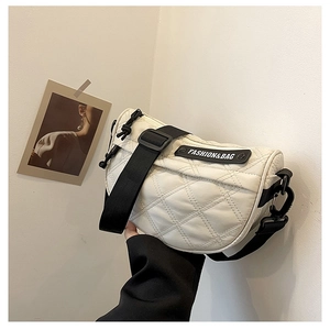 Detail of white quilted crossbody bag with FASHION&BAG logo and black fabric strap