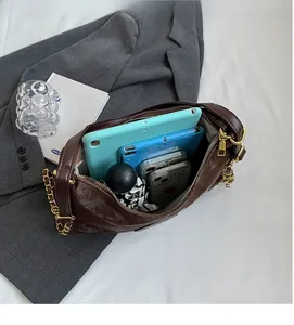 Interior view of brown hobo bag showing capacity for two tablets and a folding umbrella