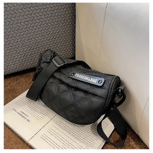 Detail of the black quilted nylon crossbody bag with adjustable wide strap and text logo