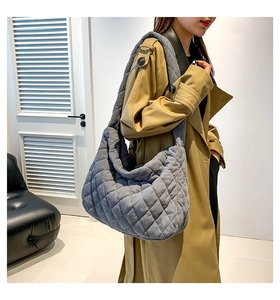 Close-up of grey corduroy quilted tote bag showing textured diamond patterns and wide strap