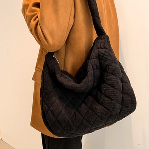Large black corduroy tote bag with diamond quilting and wide shoulder strap