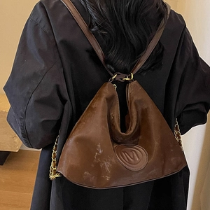 Vintage dark brown leather tote bag with M-embossed patch and gold chain strap