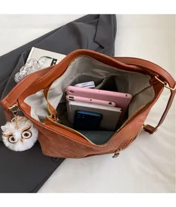 Interior view of brown corduroy tote bag showing large storage capacity and inner pocket