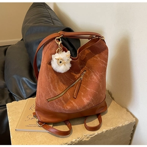 Detail of vintage brown corduroy tote with owl charm and leather accents