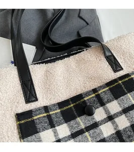 Detailed view of plush lamb wool tote bag with checkered pocket and reinforced stitching