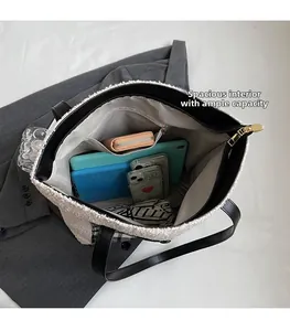 Detailed top view of the spacious interior with zipper pocket in a plush tote bag