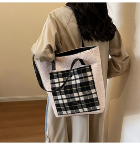 Detail of plush tote bag showing contrast plaid pocket and dual leather shoulder straps
