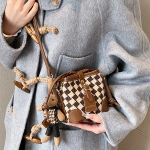 Mini retro checkered crossbody bucket bag with brown leather trim and plush bunny charm