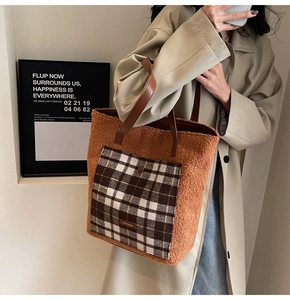 Detail of caramel teddy fleece tote bag with plaid pocket and leather trim on a model