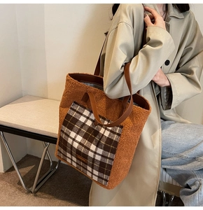 Detail of caramel faux fur tote bag featuring classic plaid pocket and brown leather straps