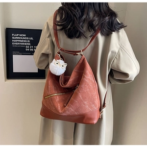 Detail of caramel corduroy tote bag showing textured fabric and leather strap splicing