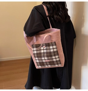 Detail of pink faux fur shoulder bag with plaid pocket and large interior for winter