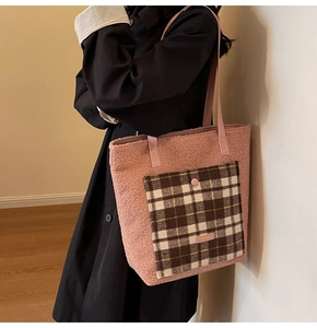 Detailed close-up of pink fluffy tote bag with checkered pocket and leather strap