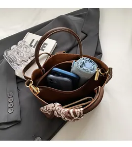 Top view of brown leather bucket bag showing large capacity for phone and umbrella