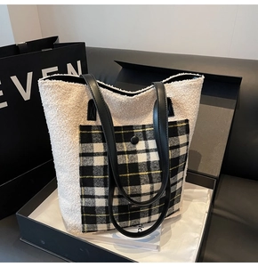 Detail of soft winter faux fur tote bag featuring a plaid pocket and leather shoulder straps