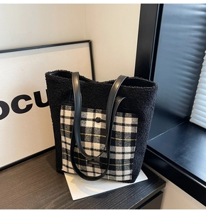 Detail of plush fleece tote bag featuring black and white checkered pocket and brand tag