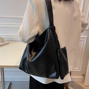 Große schwarze Hobo-Tasche aus PU-Leder mit passendem Beutel, am Modell gezeigt
