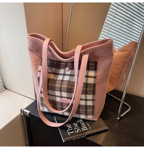 Detail of pink faux shearling tote bag with a checkered pocket and leather straps