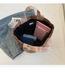 Spacious interior of quilted nylon tote bag with magnetic closure for tablet and essentials
