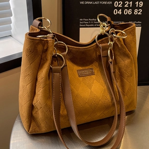 Brown quilted faux suede tote bag with large capacity and elegant gold chain straps