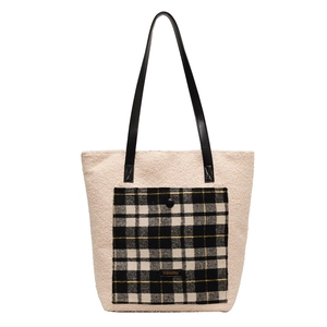 Chic off-white faux fur tote bag with checkered pocket and black leather straps