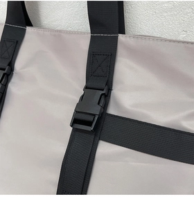 Detail of high-density nylon tote bag with reinforced cross stitching and durable buckle