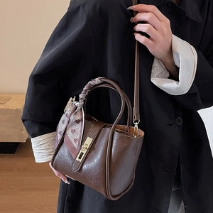Retro dark brown bucket bag with lychee texture, golden lock, and patterned silk scarf