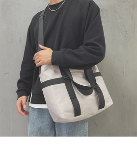 Close-up of a versatile silver tote bag featuring durable wide straps and adjustable side buckles