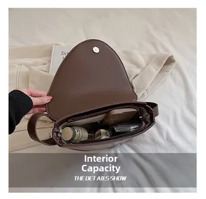 Dettaglio dell'interno spazioso e della tasca con zip della borsa in pelle marrone