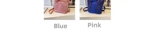 Detail view of pink and blue canvas handbags showing wide handles and adjustable straps