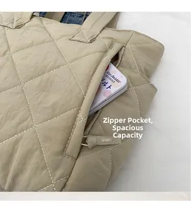 Close-up of khaki quilted tote bag featuring a hidden zipper pocket and spacious interior