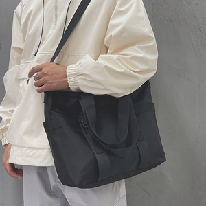 Black large-capacity nylon tote bag with wide strap for commuting and crossbody wear