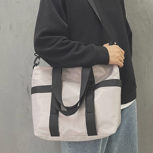 Large gray nylon tote bag with black straps for commuting and versatile crossbody wear
