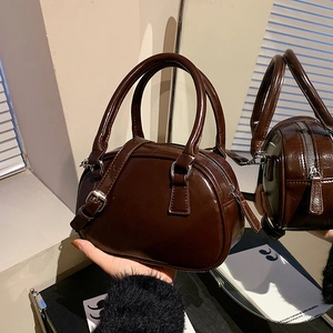 Vintage dark brown glossy leather Boston handbag with adjustable shoulder strap and dual handles