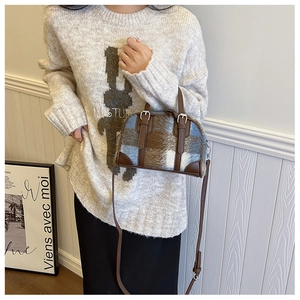 Detail view of the plush plaid Boston bag with blue and brown faux fur texture