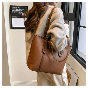 Close-up of brown litchi pattern tote bag with fine stitching and slim shoulder straps