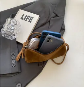 Top view of compact brown suede Boston bag showing interior space for two smartphones