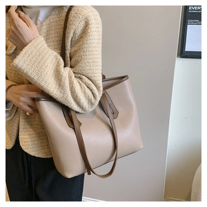 Model showing large capacity apricot tote bag with contrasting brown handles and lychee texture