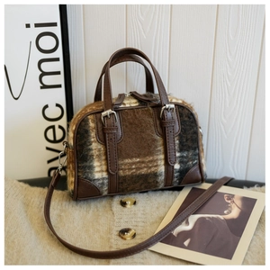 Detailed view of the plaid wool Boston bag with brown leather handles and straps