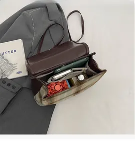 Internal view of a dark brown large capacity backpack with tablet and daily essentials