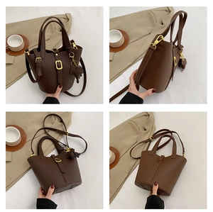 Detailed views of a vintage dark brown bucket bag with lychee texture and gold hardware
