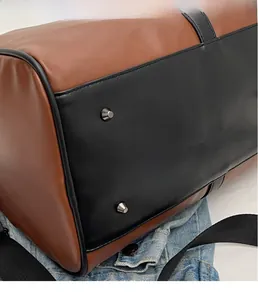 Close-up of metal studs on the bottom of a leather travel bag for protection